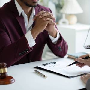 Young professional lawyer consulting with his client, listening Young professional lawyer consulting with his client, listening to client situation about the case.